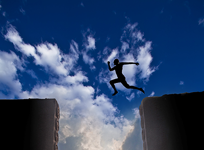 A man leaps from one building to another