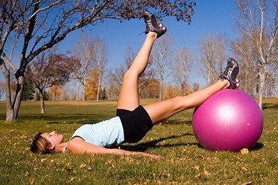 Woman exercising with a pilates ball