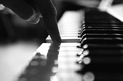 Piano key being pressed